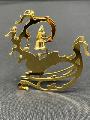 Gold sleigh with reindeer and bell on a gray background