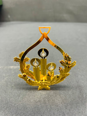 Gold decorative item on a gray surface