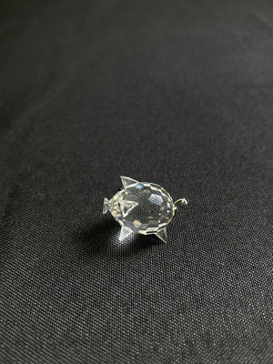 Crystal fish-shaped brooch on a black fabric background