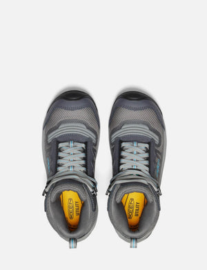Pair of gray hiking shoes with yellow sole on a white background