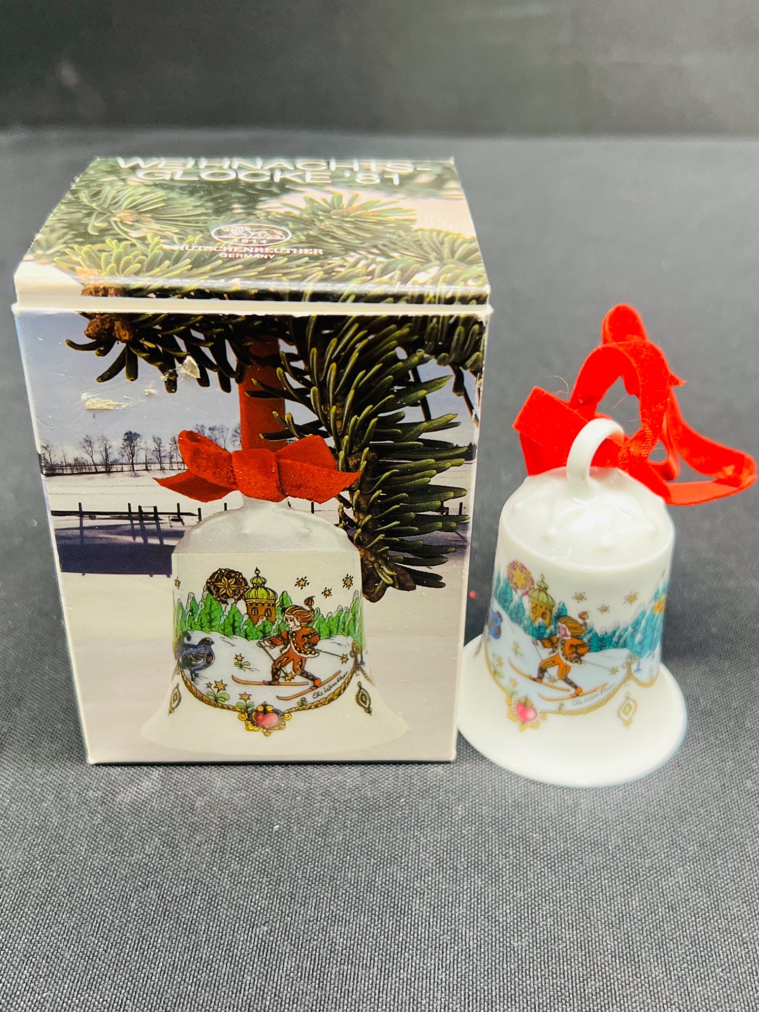 Christmas bell with decorative design and packaging on a gray background