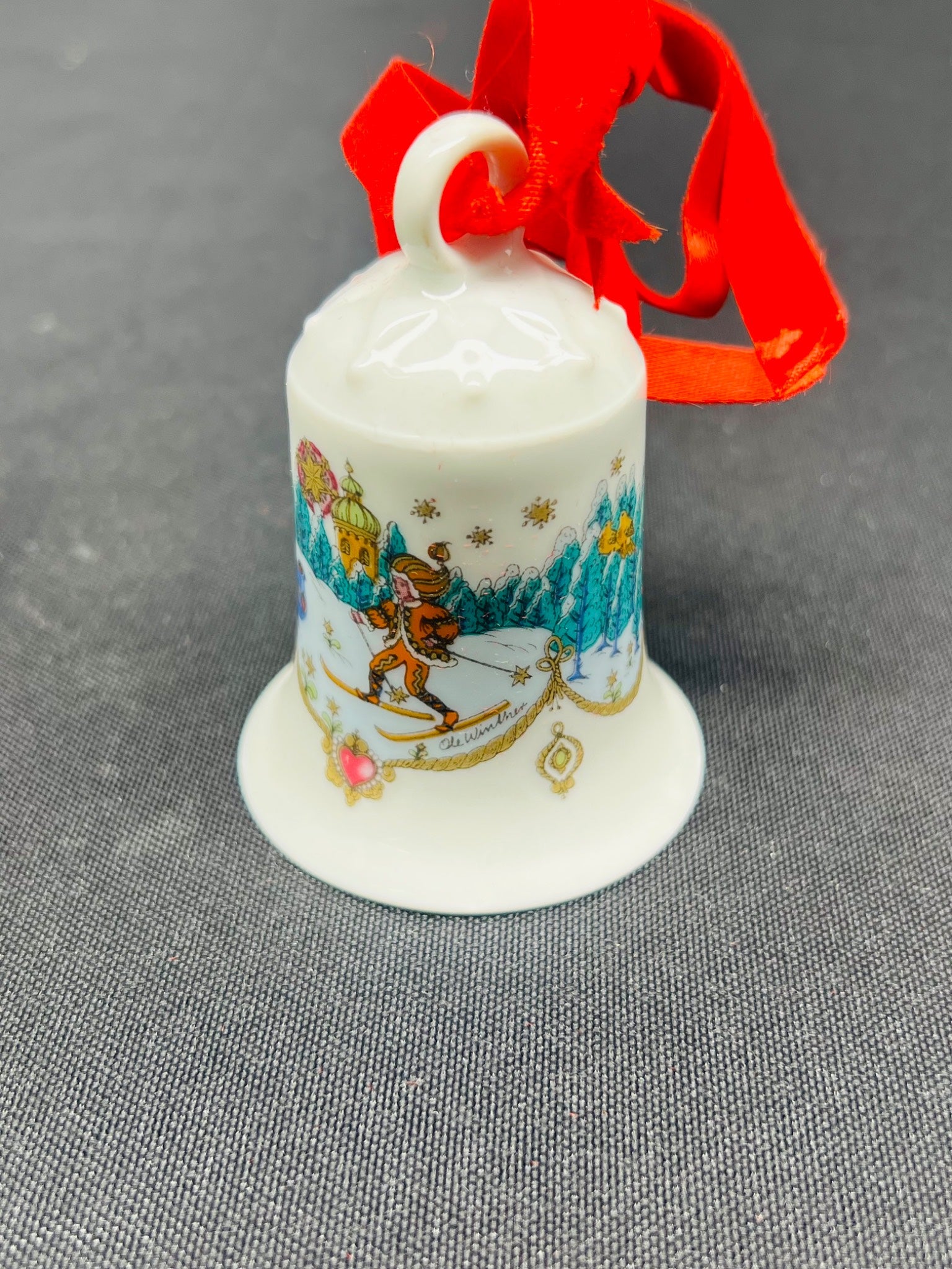Decorative bell with a skier design on a gray background