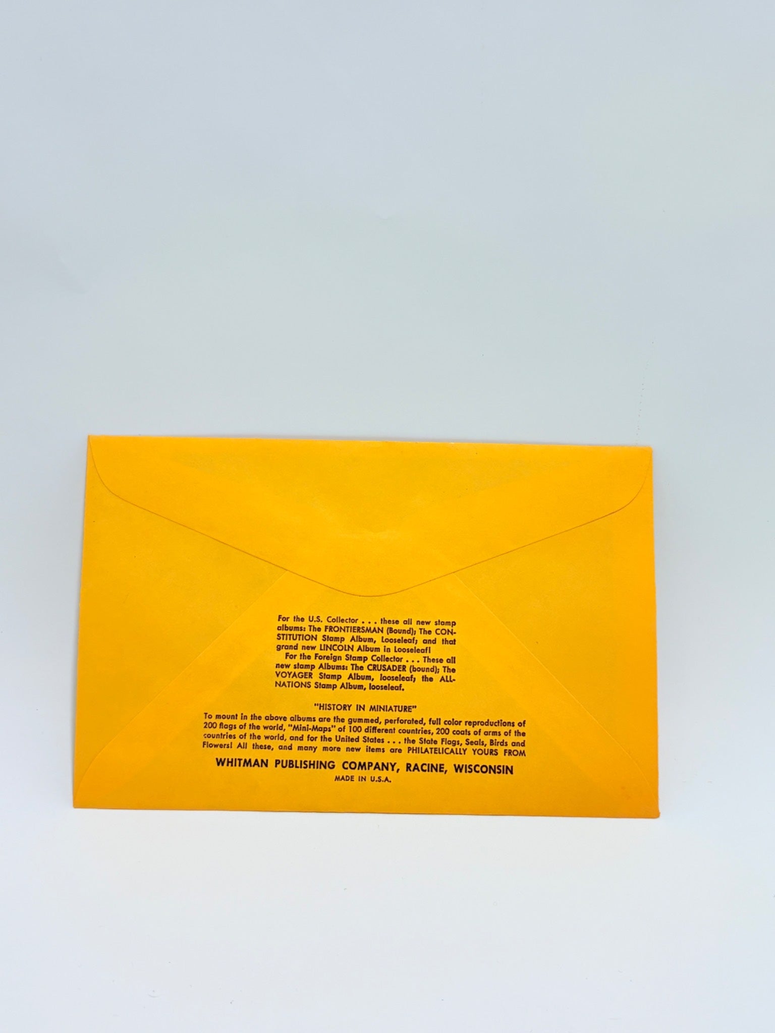 Yellow envelope with black text on a light gray background