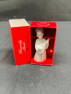 Decorative angel figurine in a red box on a gray surface