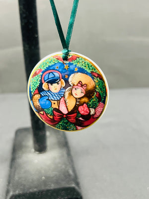 Colorful pendant with cartoon characters on a stand against a neutral background