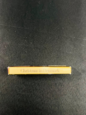 Gold book titled 'Christmas in Denmark' on a black background