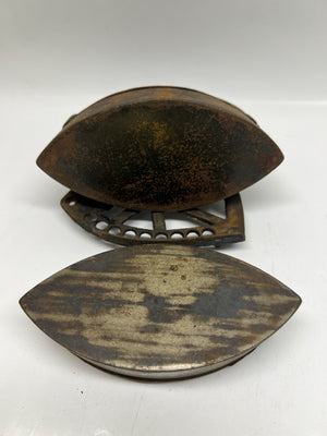 Vintage metal object with a rusted surface on a white background