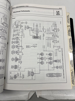 Open book showing an electrical schematic diagram on a white background