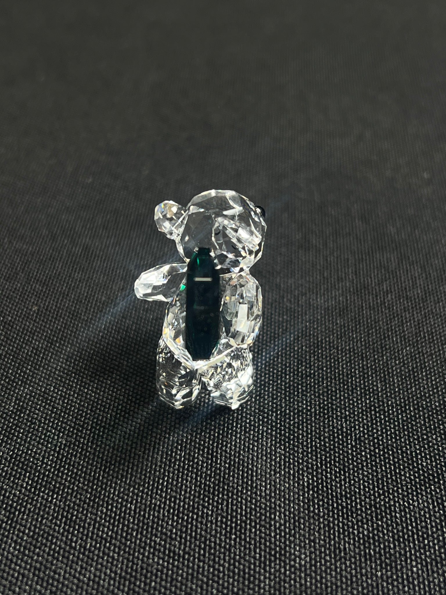 Crystal bear figurine on a black textured background