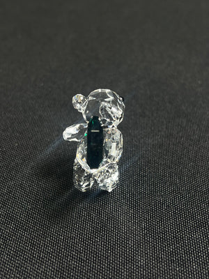 Crystal bear figurine on a black textured background