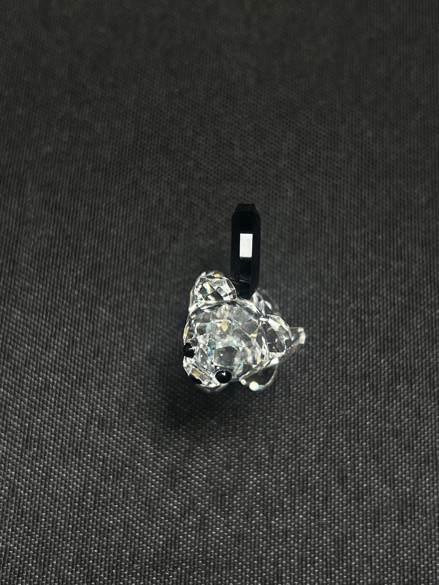 Clear crystal pendant on a black background