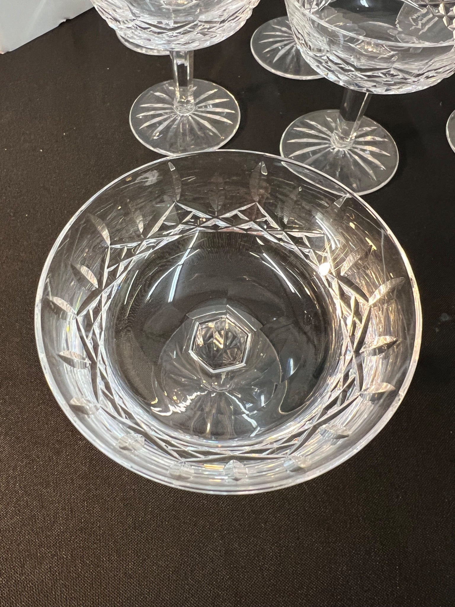 Close-up of a crystal glass with intricate cut patterns on a dark surface