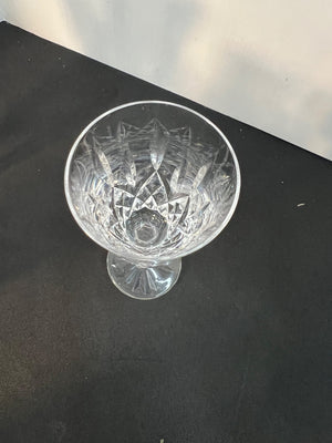 Crystal glass with cut design on a black surface