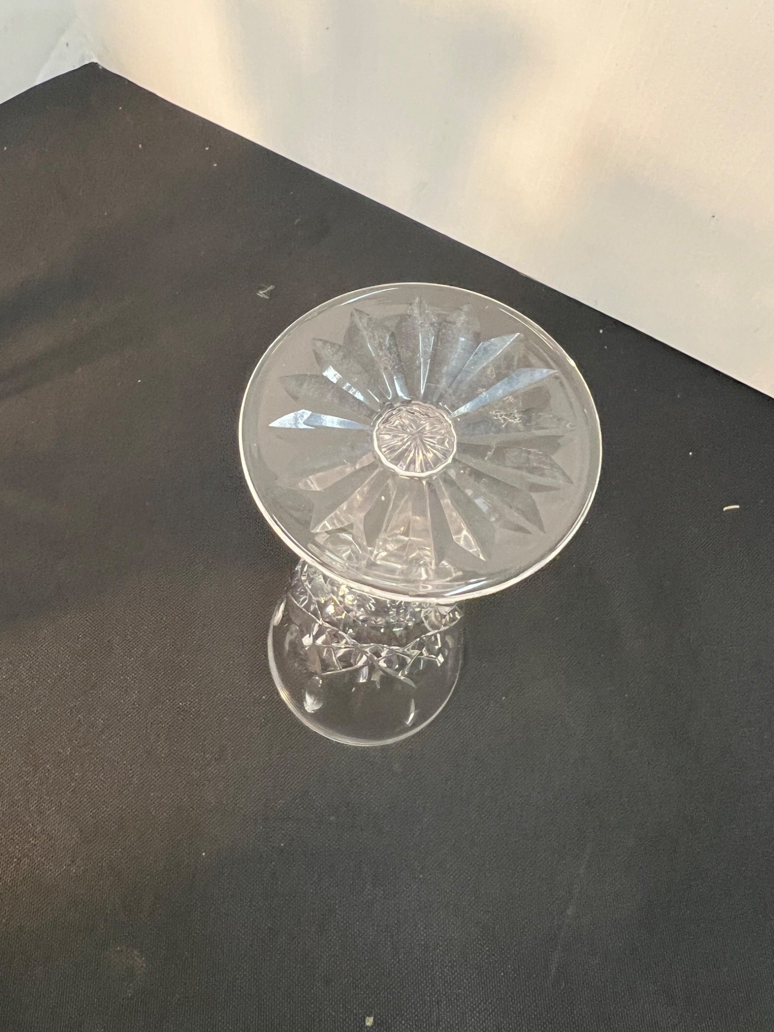 Clear glass object with engraved design on a black surface