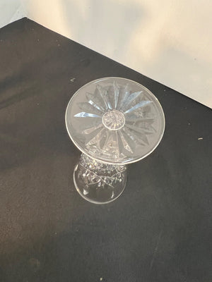 Clear glass object with engraved design on a black surface