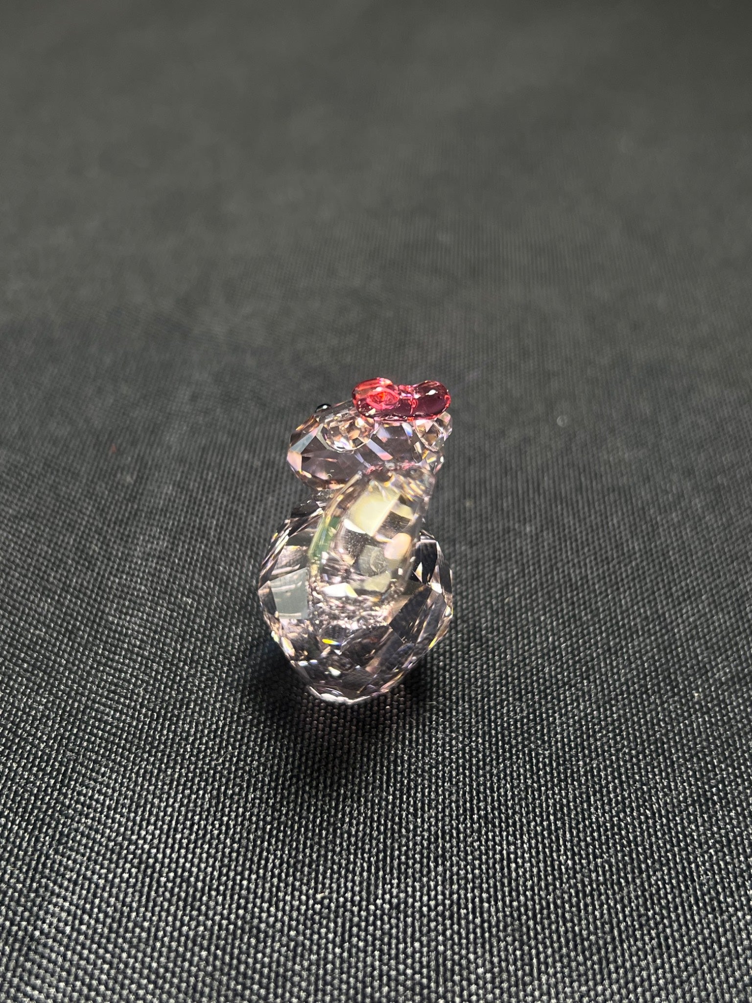 Crystal seashell charm on a textured black background