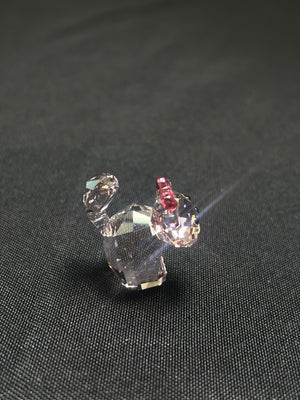 Crystal dog figurine on a dark fabric background