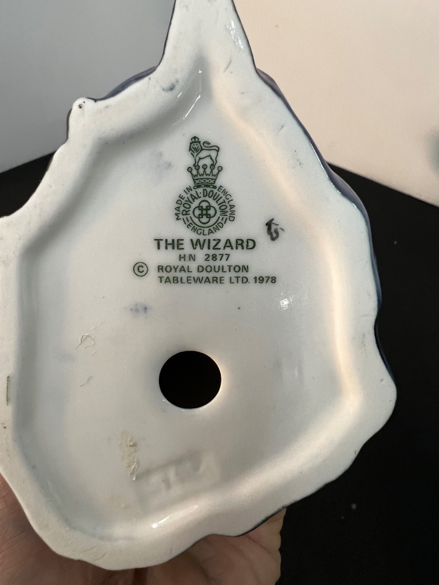 Ceramic product with 'The Wizard' branding on a plain background