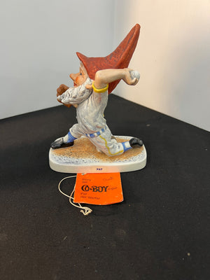 Gnome figurine with a red hat on a black surface, featuring a Go-Boy tag.