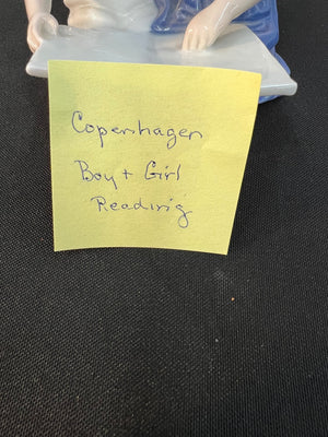Yellow sticky note with 'Copenhagen Boy & Girl Reading' text on a black background