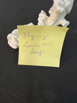 Yellow sticky note with handwritten text on a black background