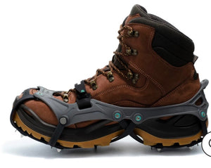 Brown hiking boot with crampon attachment on a white background