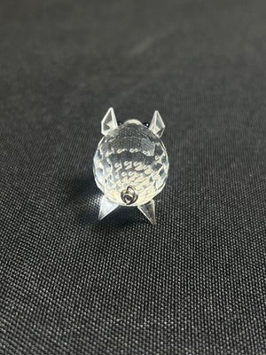 Clear crystal object shaped like a cat on a black background