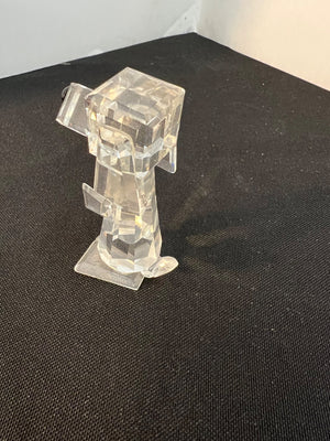 Clear plastic figurine on a black surface