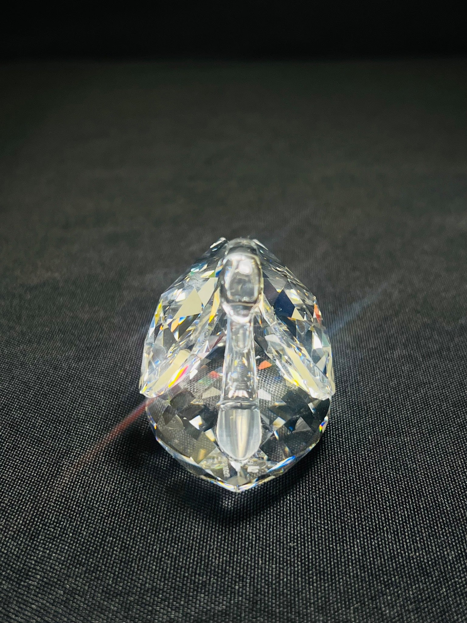 Clear crystal object on a dark fabric background