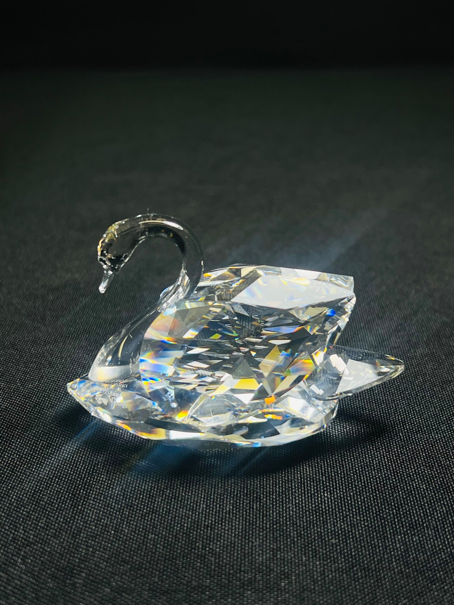 Crystal swan figurine on a black background