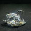 Crystal swan figurine on a black background