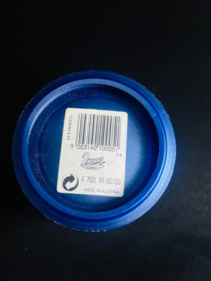 Blue plastic cap with a barcode label on a black background