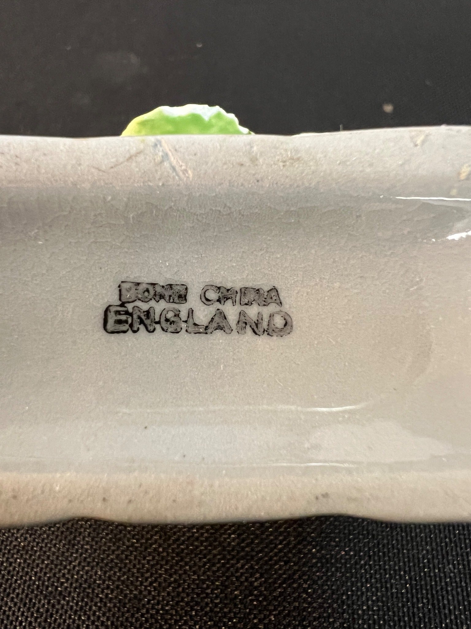 Stylized 'Bone China England' text on a ceramic product.