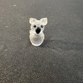 Clear glass koala figurine on a dark textured surface
