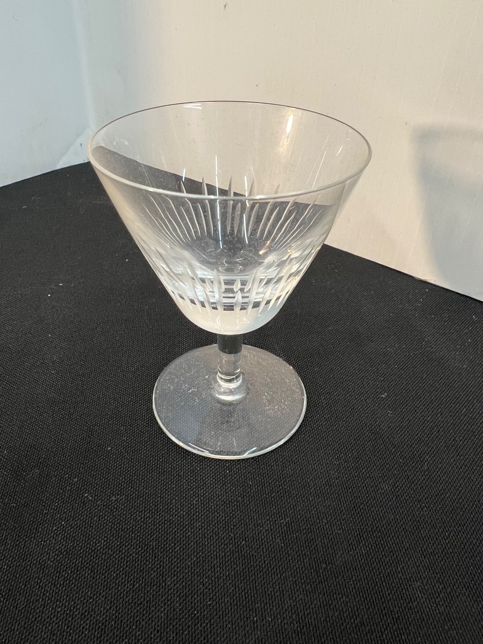 Clear glass with etched design on a black surface