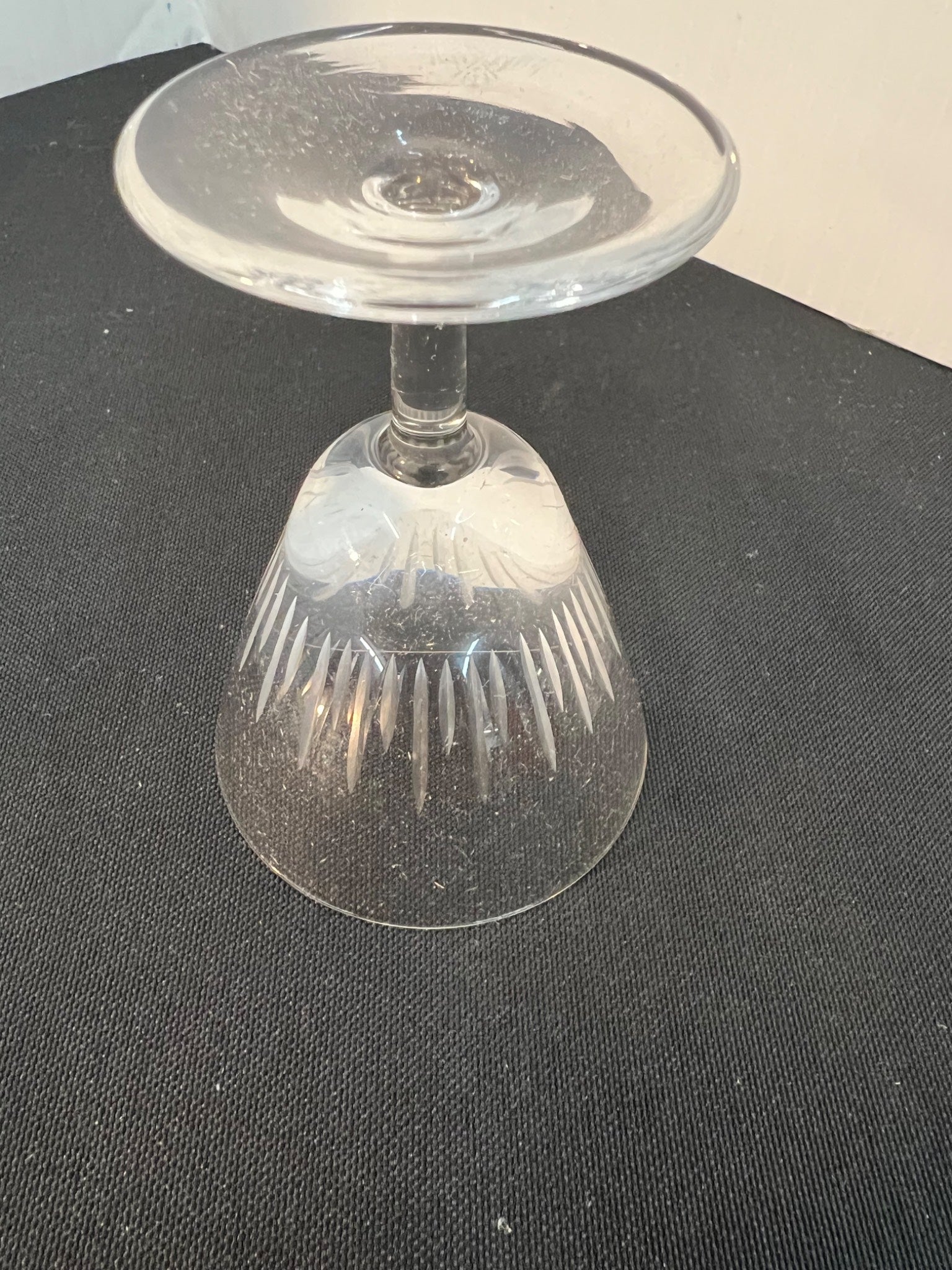 Clear glass candle holder on a black surface