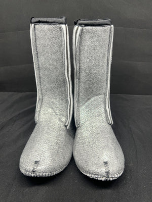 Pair of gray boots with white trim on a black background