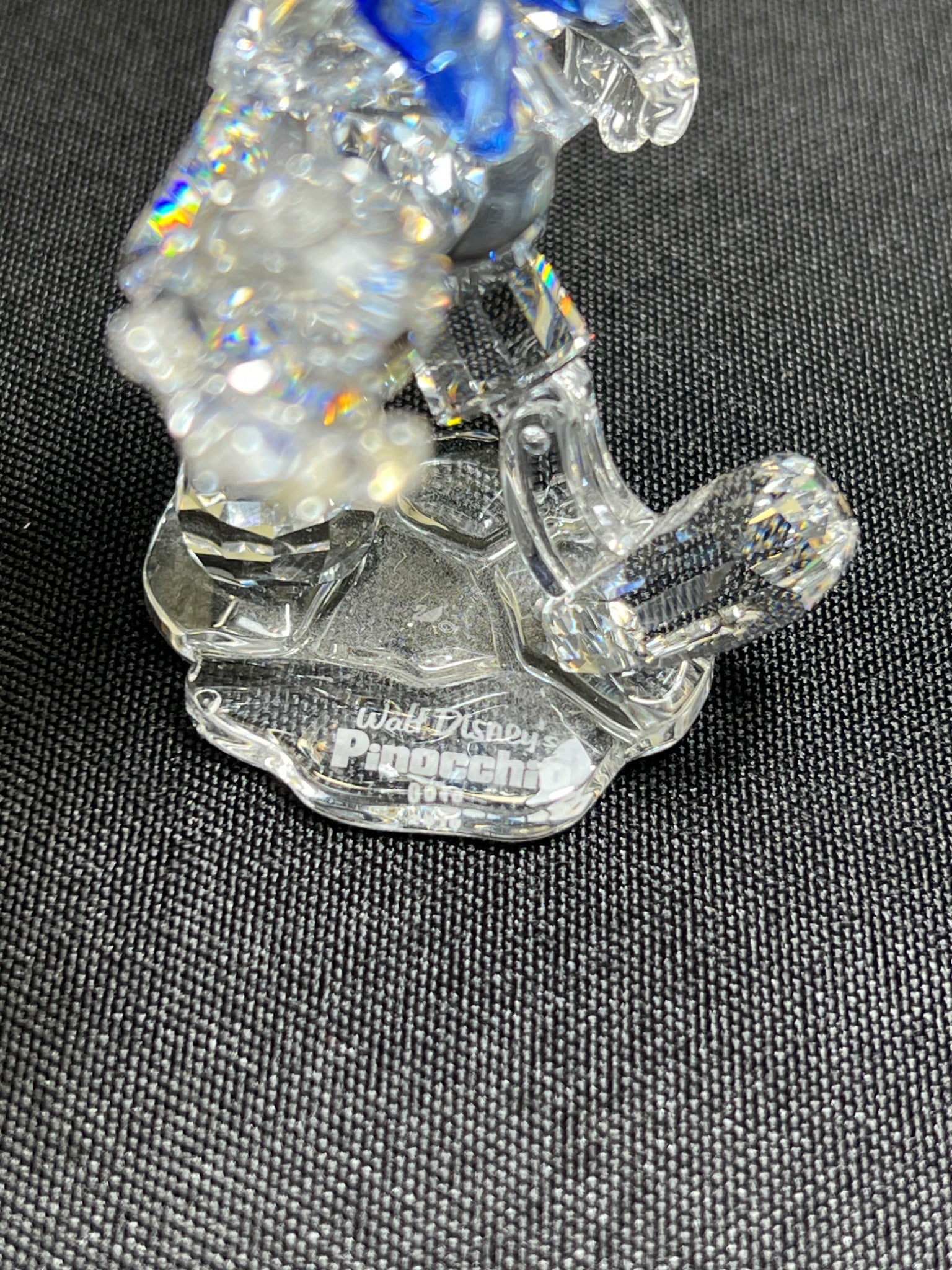 Crystal figurine of a character from Walt Disney on a dark background