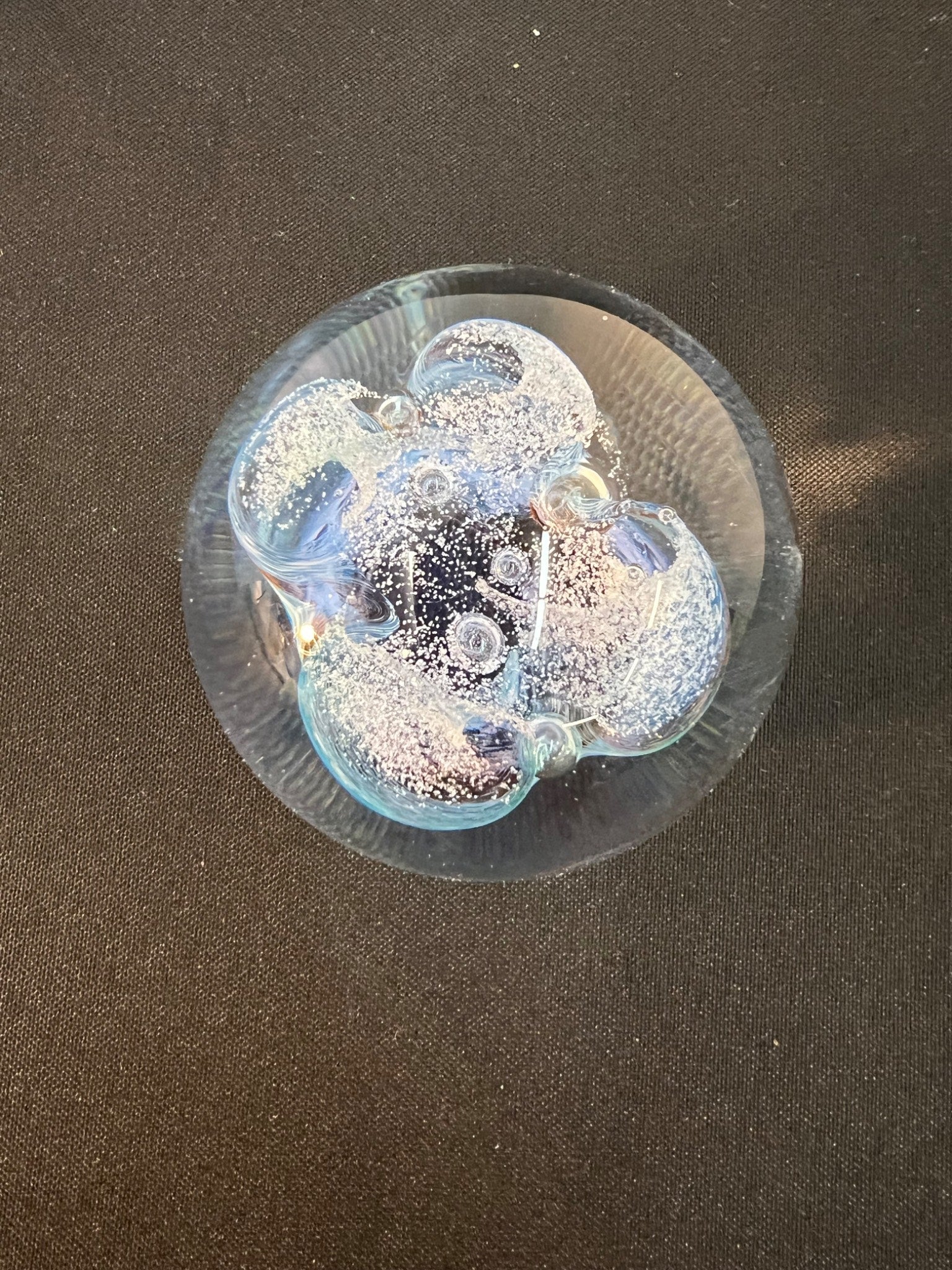 Transparent sphere with bubbles on a dark background