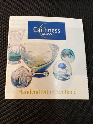 Caithness Glass promotional material with glass pieces on a black background