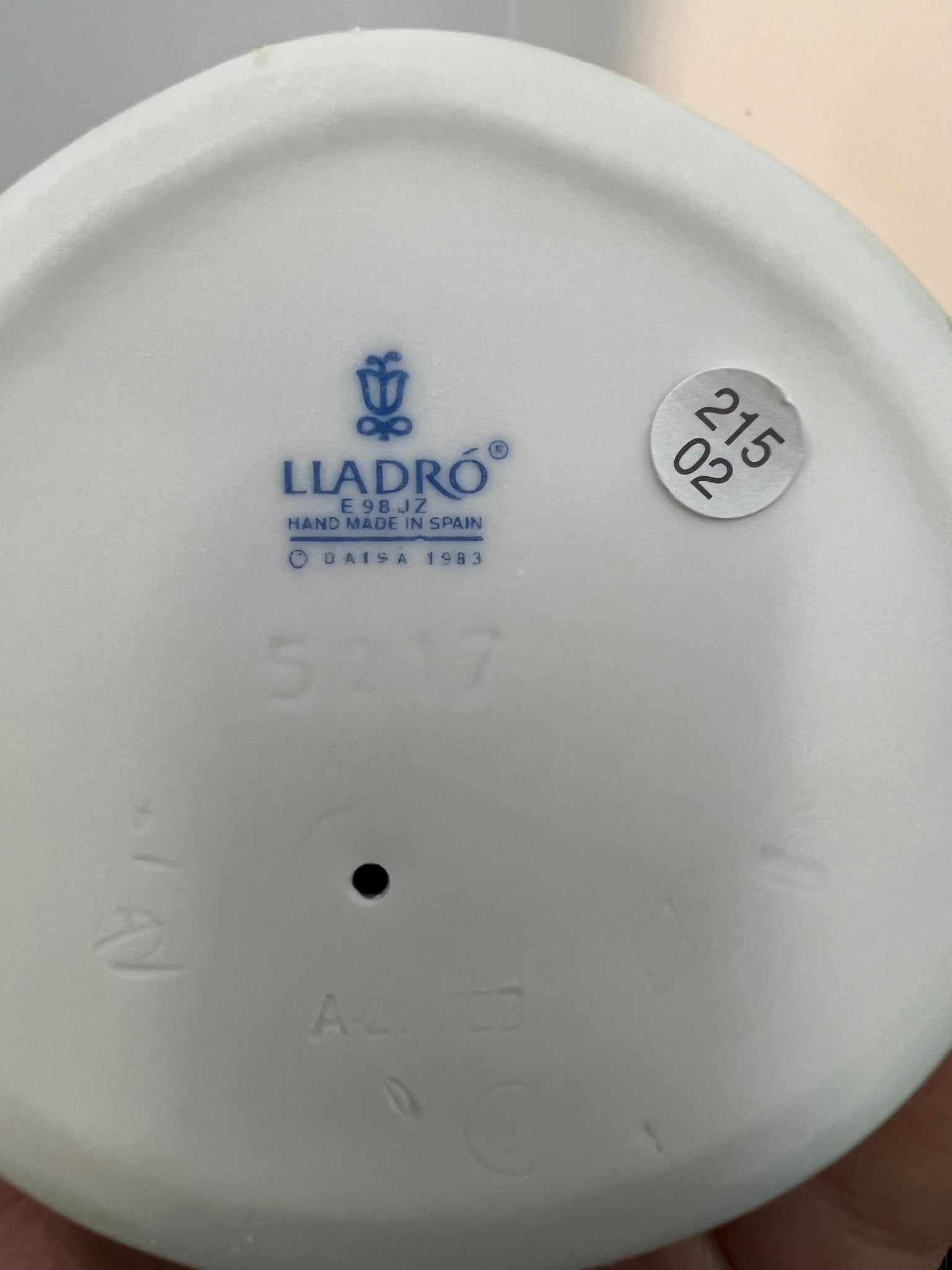 Close-up of a Lladró product with branding and model number on a white background