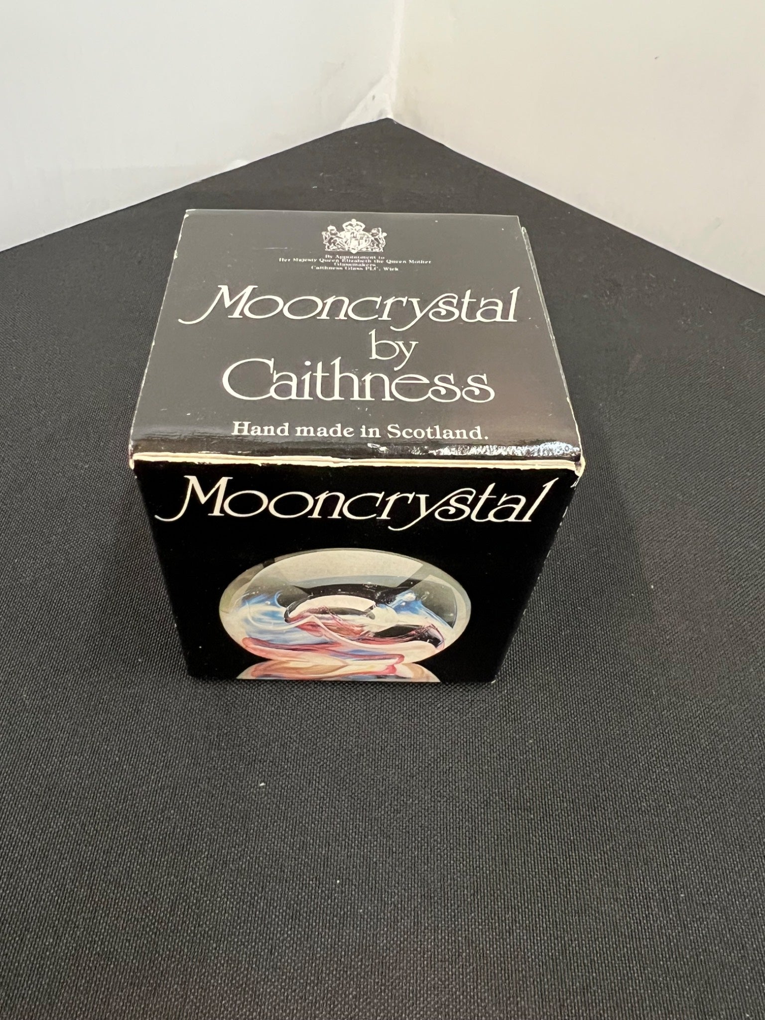 Box of Mooncrystal by Caithness on a black surface