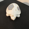 Decorative turtle figurine with geometric patterns on a black surface