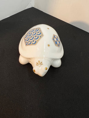 Decorative turtle figurine with geometric patterns on a black surface