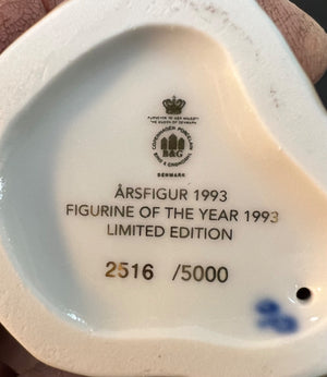 Back of a ceramic figurine with branding and limited edition details