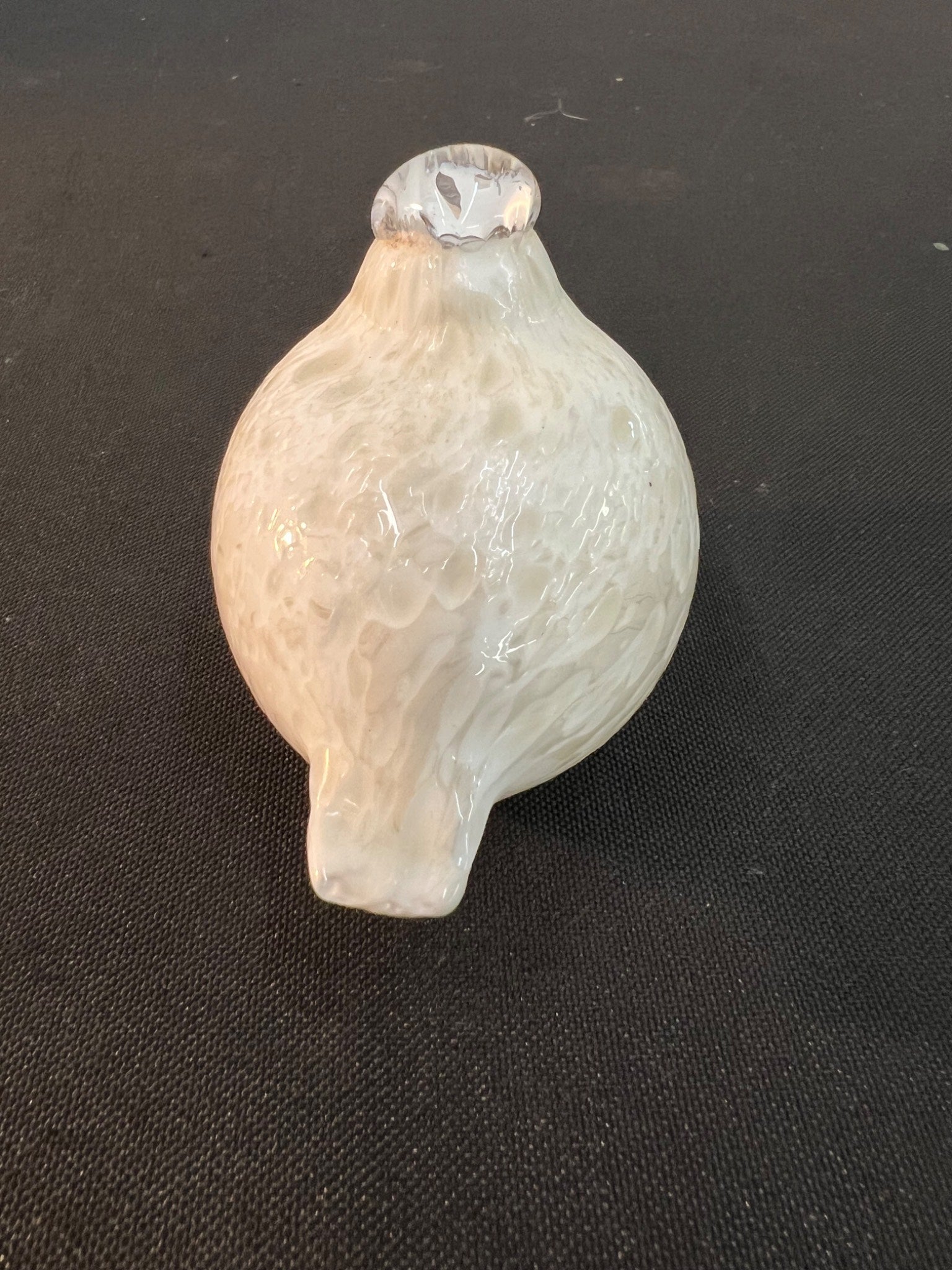 Clear glass object on a black background