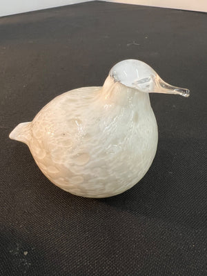 Glass duck ornament on a black surface