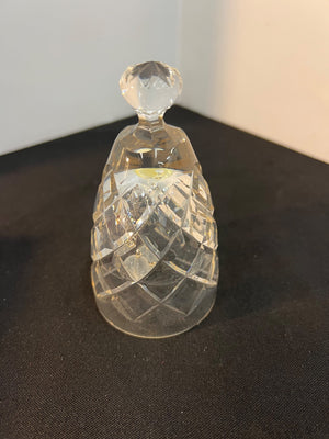 Clear glass bell-shaped object on a dark surface