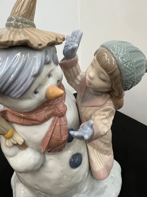 Decorative figurine of a snowman and a girl with a white background