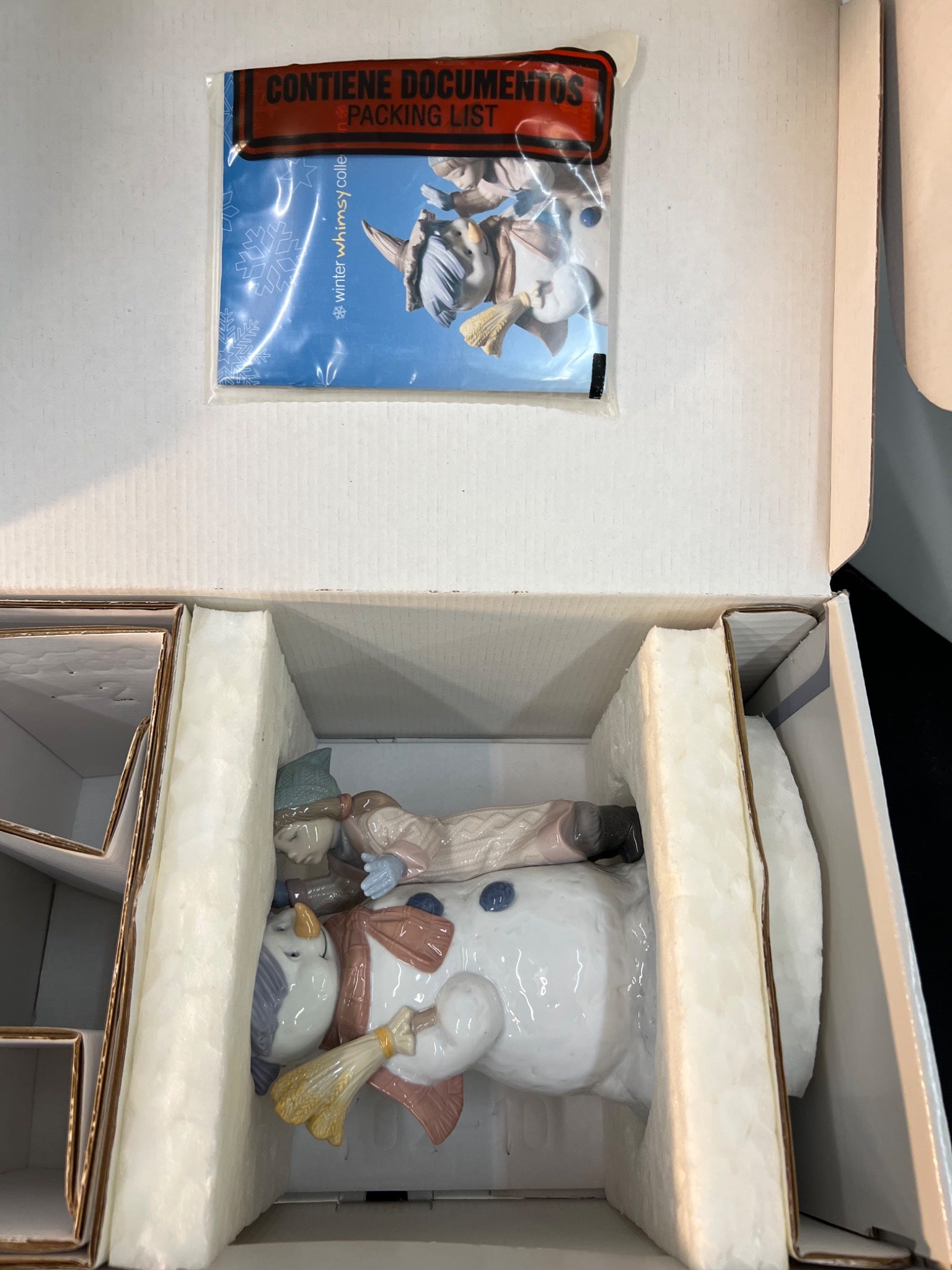 Decorative ceramic figure in a box with a packing list on top